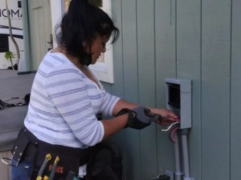 Licensed electrician wiring an exterior subpanel in Wyldwood