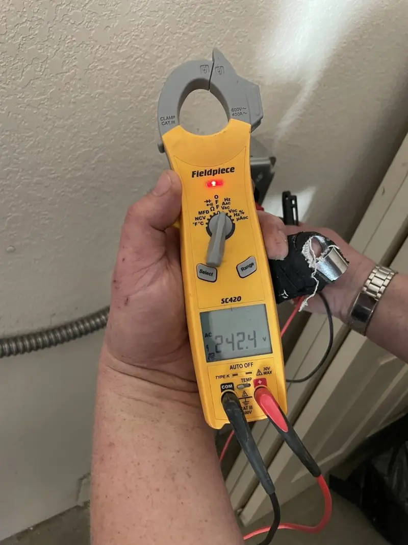 Voltage testing with clamp meter during Outlet Installation in Wyldwood